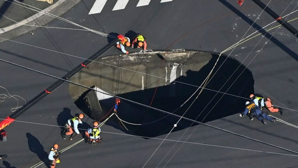 Swimming pool-sized sinkhole swallows truck in Japan, trapping driver | World News