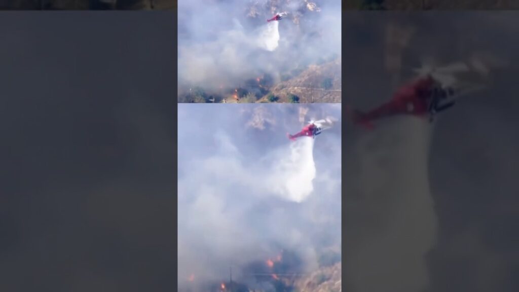 Footage shows a helicopter dropping water on wildfire #shorts