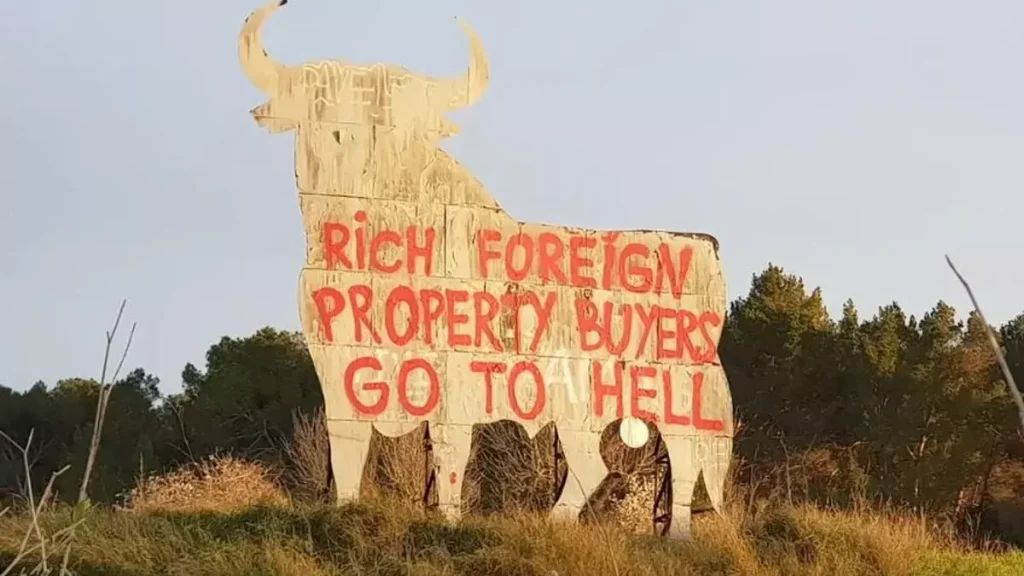 Locals celebrate graffiti on Mallorca’s Osborne Bull statue that says ‘rich foreign property buyers to go to hell’