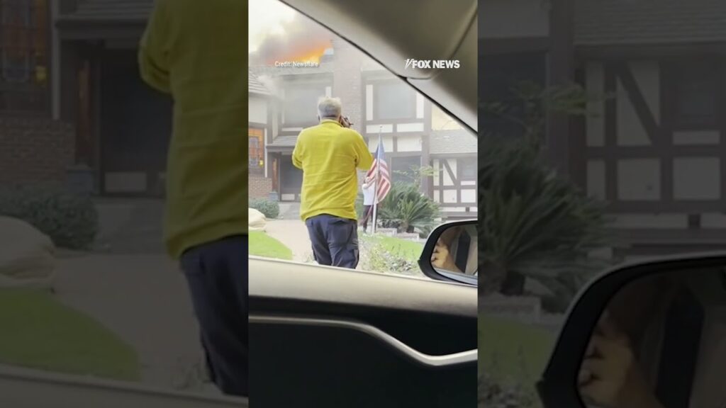 Man rescues American flag from stranger’s yard as home burns behind him