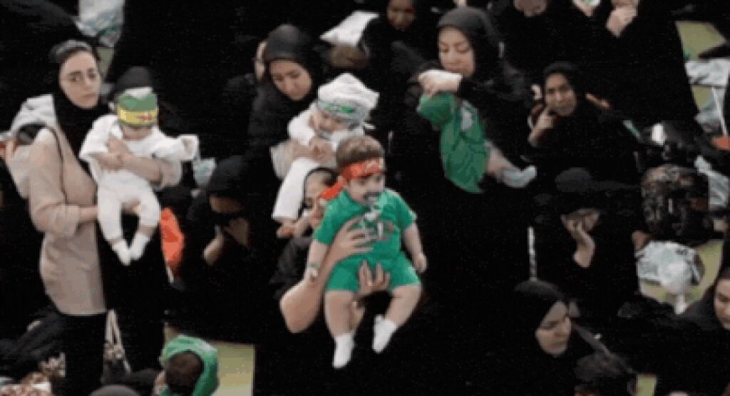 Hosseini infants ceremony: In war’s shadow, hundreds of Iranian mothers offer babies as martyrs – video