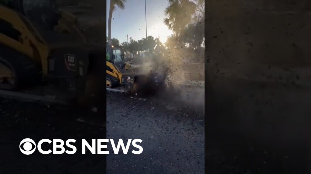 Crews in Sarasota, Florida, remove mud left by Hurricane Milton