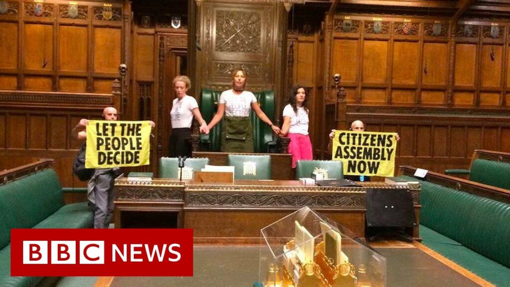 Extinction Rebellion climate activists glue themselves together in UK Parliament – BBC News