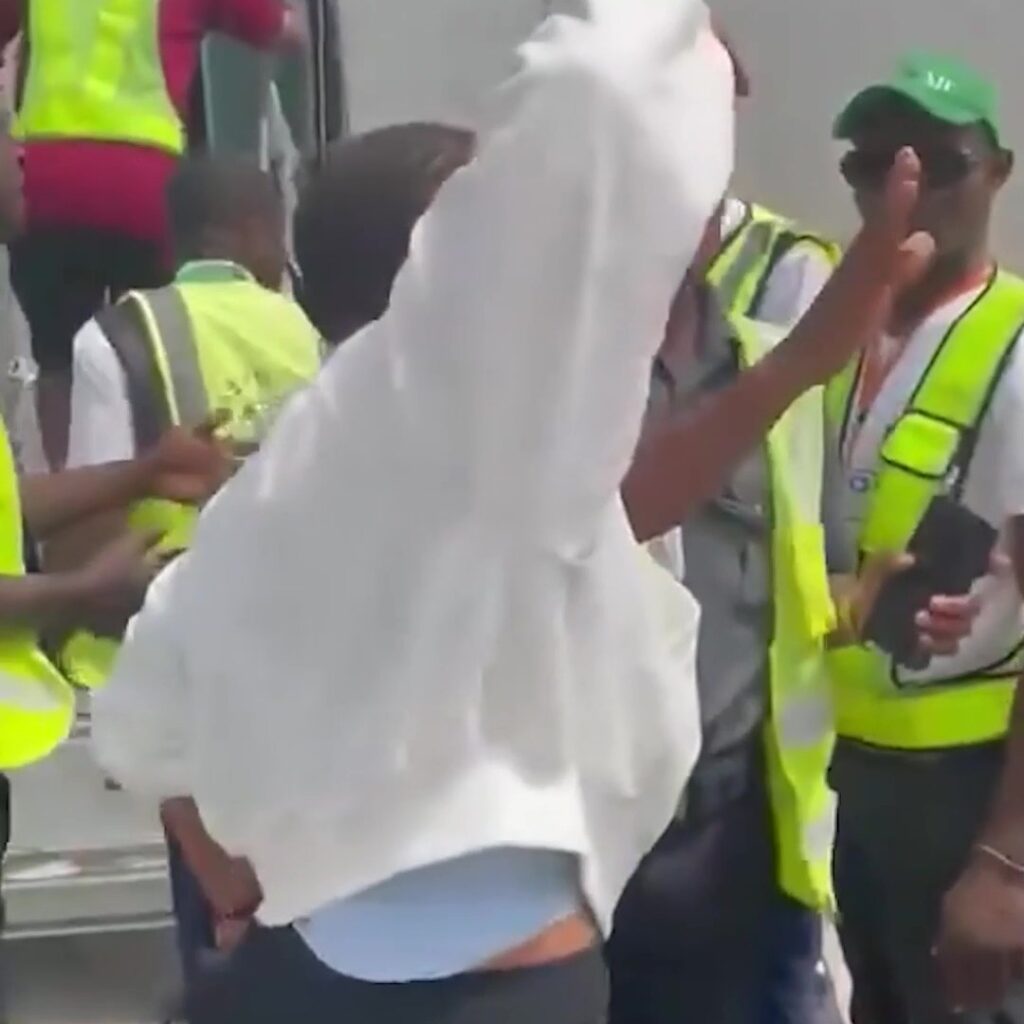 Moment plane passenger bundled screaming onto airport bus after punching stewardess & ‘refusing to turn off her phone’