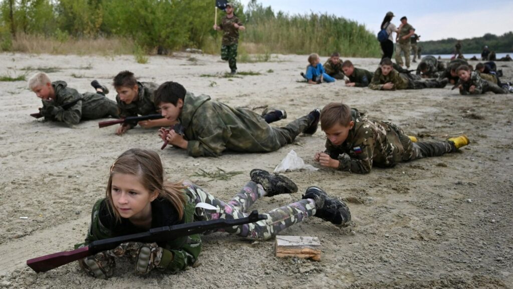 Chilling moment Russian kids crawl with AK-47s & throw grenades as Vladimir Putin prepares his next generation army